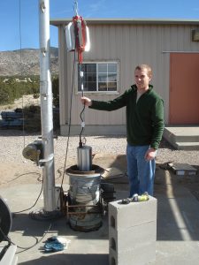 Adam Ringler installing broadbend sensor in borehole.