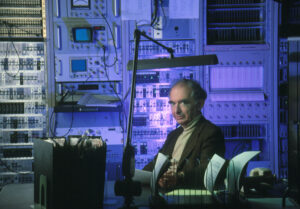 Geophysicist Bill Joyner in front of seismographic recording equipment at the USGS's laboratory at Menlo Park, California.