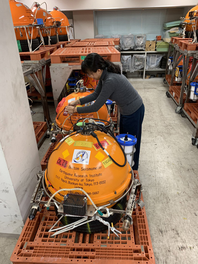 HyeJeong Kim helping to organize the ocean bottom seismometers that came back to the Earthquake Research Institute.