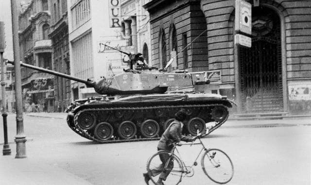 Child with his bicycle running away from a military tank during September 1973 Chilean coup.