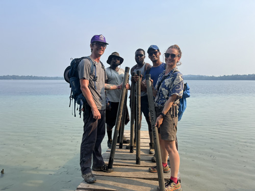 Research team standing on dock with sediment cores from Lake Lachua.