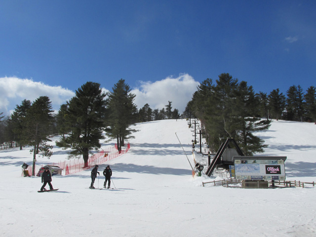 Base of Mount Nashoba ski area in winter with skiers.