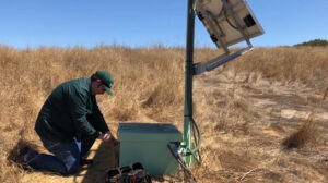 USGS researcher installing ShakeAlert sensor near San Francisco